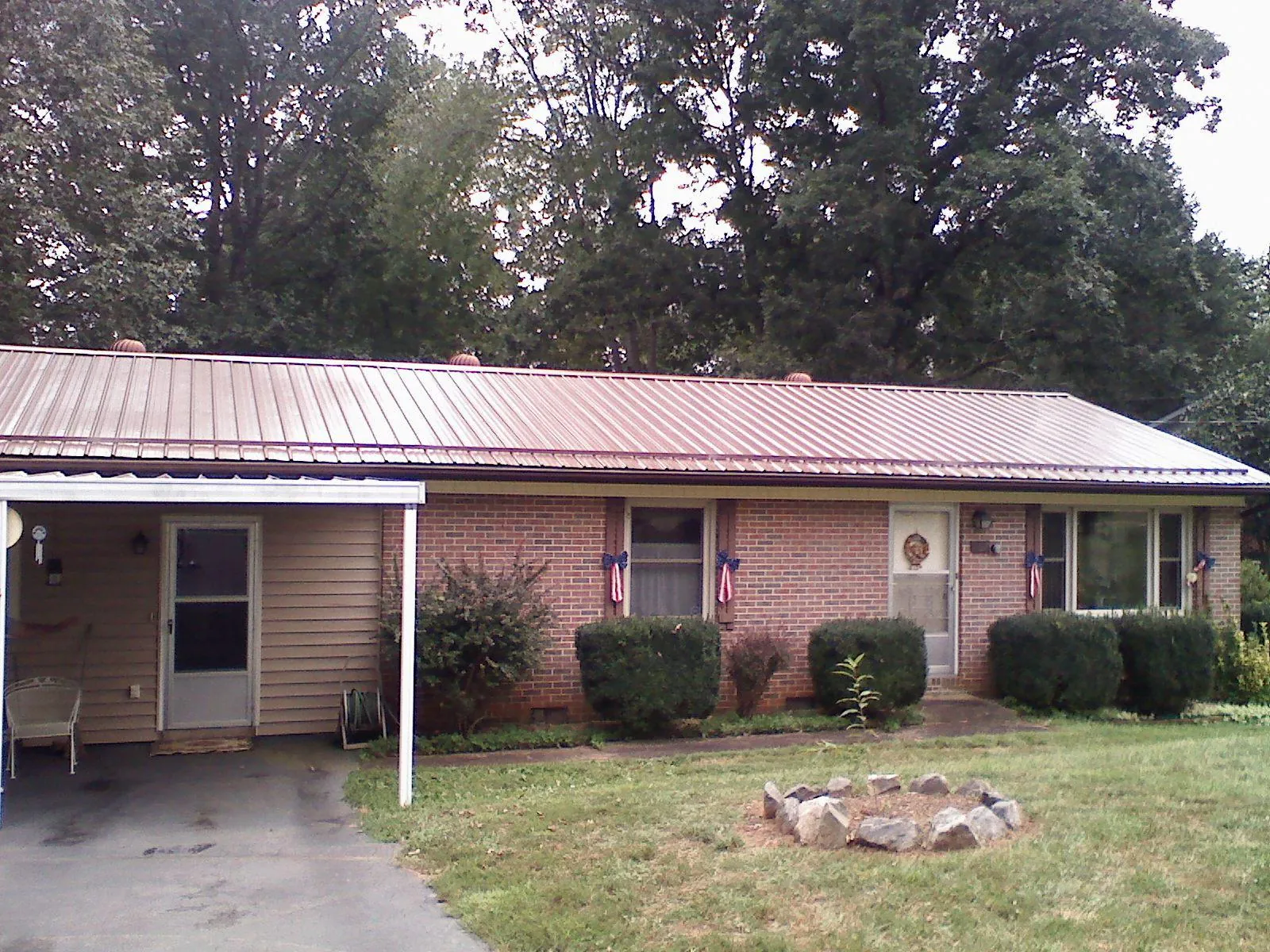 Bronze metal roof and carport on a brick ranch home — Roof Repair work by our crew in Street